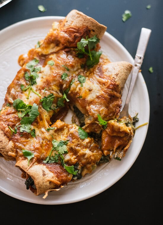 Hearty spinach artichoke enchiladas with a simple homemade red sauce! - cookieandkate.com